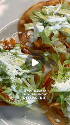 two flatbreads with lettuce and cheese on them sitting on a plate