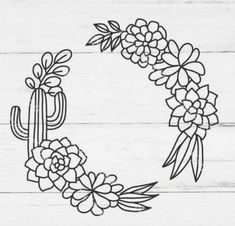 a wreath with flowers and cactus on it