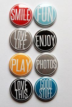 six buttons with the words smile, love, enjoy and play in different colors on them