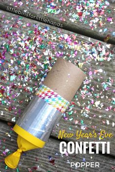 a new year's eve confetti popper on a picnic table with sprinkles