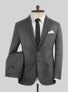 Attain a fashionable and modish look with our Napoleon Genova Stripe Dark Gray Wool Suit. Crafted from a superior blend of wool, it presents a dark gray color adorned with a subtle stripe design, marrying timeless charm with a touch of modern sophistication ensuring a distinguished look and a comfortable feel. Whether you're making a powerful statement or embracing casual sophistication, this suit ensures you command the room and every stylish moment with effortless poise and confidence. 
  Look Includes   Napolean Genova Stripe Dark Gray Wool Fabric  Two Button Jacket Style  Notch Lapel  Horn Royal Black Buttons  Single Vent  Three Cuff Buttons  Two Welted Back Pockets on Trousers   Click 'Customize Now' to modify the look if needed. 
 
Lining: Viscose, Dry Clean, Pants can be lightly was Blue Tweed Jacket, Tweed Shirt, Peaky Blinders Suit, Grey Wool Suit, Dark Gray Color, Green Suit, Grey Tweed, Custom Suit, Linen Suit