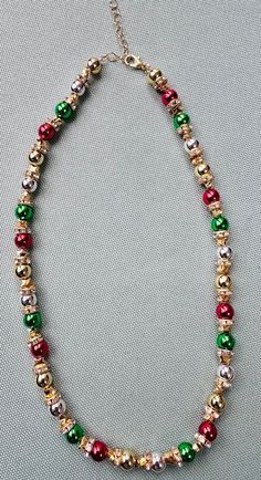 christmas themed multicoloured necklace with gold beads  can be made with silver or other required colours too  lenghth of necklace 15 inches ]has an adjustable chain to it Gold Round Beads Jewelry For Christmas, Gold Necklace For Festive Christmas Occasion, Gold Beaded Necklace For Christmas, Festive Gold Necklace With Colorful Beads, Christmas Gold Beaded Necklace, Holiday Festive Jewelry With Colorful Beads, Holiday Gold Jewelry With Colorful Beads, Festive Holiday Jewelry With Colorful Beads, Holiday Gold Beaded Necklace