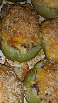 green peppers stuffed with cheese on top of some breaded crackers and other food items