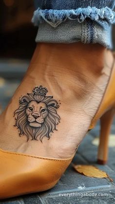 a woman's foot with a lion tattoo on it