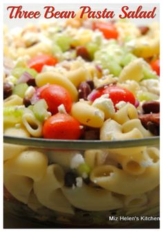 a pasta salad in a glass bowl with the words three bean pasta salad above it