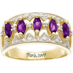 a yellow gold ring with three purple stones