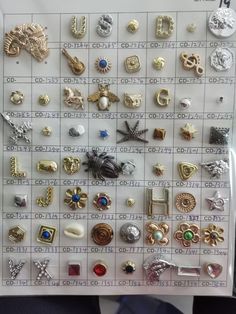 there are many different types of brooches on this board, all in gold and silver