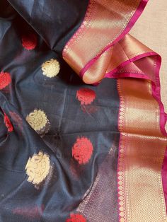 Beautiful Light Weight Semi-Banarasi Silk Saree with Banarasi Borders in combination of Red, Pink and Purple. Buttis all over the Body of the Saree in red and Golden. Item : Saree Color : Black, Red, Pink and Purple Base Fabric : Semi-Banarasi Silk Blouse piece : Comes with Blouse piece Blouse material : Semi-Banarasi Silk Work : Zari weaving butti all over, borders and pallu Fall & Edging: Comes with Fall and edging (Pico) and tassels attached Occasion: Party, Wedding, Festival, Wedding, Tr Red Banarasi Silk Saree With Sheer Dupatta, Red Tissue Silk Dupatta For Diwali, Celebration Banarasi Silk Blouse With Sheer Dupatta, Celebration Blouse With Sheer Dupatta In Banarasi Silk, Festive Traditional Wear With Sheer Dupatta For Puja, Celebration Chanderi Salwar Kameez With Zari Weaving, Red Tissue Silk Dupatta For Puja, Banarasi Silk Traditional Wear With Sheer Dupatta For Celebration, Diwali Anarkali Set With Sheer Dupatta For Puja