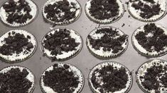 chocolate cupcakes with white frosting and oreo cookies on top are ready to go in the oven