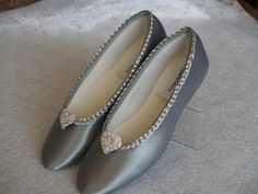 Beautiful and simple comfortable flats! Dyed to silver and hand trimmed with a beautiful braided metallic sequins trim, and a PAIR OF HEARTS crystal brooch on the front enhances this classic style! If, in doubt of silver tone, you may purchase a color sample for $3.00 USD www.etsy.com/listing/129787069/buy-color-swatch-samples-or-buy-lace For the Bride, Bridesmaids, MOBs, Wedding Anniversaries, or anyone needing comfortable flats. Outer sole is leather swede. Not for Wet areas/grass. Sizes: US S Silver Evening Ballet Flats, Elegant Silver Ballet Flats, Elegant Silver Ballet Flats With Round Toe, Silver Round Toe Ballet Flats For Evening, Silver Closed Toe Ballet Flats For Party, Silver Closed Toe Ballet Flats For Formal Occasions, Silver Ballet Flats For Party With Round Toe, Silver Closed Toe Ballet Flats, Silver Closed Toe Flats For Wedding