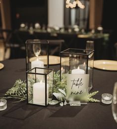 a table with candles and greenery on it