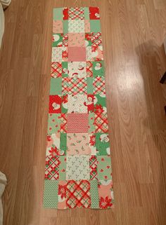 a patchwork table runner on the floor