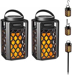 two black lanterns with orange lights on them