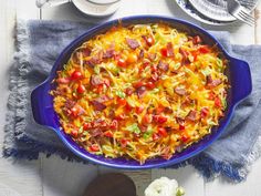 a casserole dish with sausage, peppers and cheese in it on a table