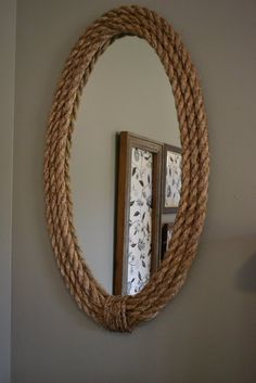 a round rope mirror hanging on the wall