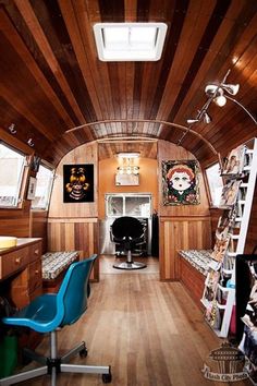 the inside of an airplane with wood paneling and blue chair in front of it