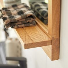 towels are folded on the edge of a window sill