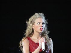 a woman in a red dress holding a white object