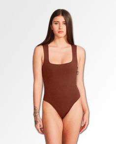 You'll look absolutely lovely when you're sporting the BB Dakota Blake Bodysuit! Sleek stretch knit shapes this trendy bodysuit that has bra friendly straps. The fitted bodice continues to thong bottoms with snap closures. Fabrication: 76% Nylon 24% Elasthane Trendy Bodysuits, Bb Dakota, Fitted Bodice, Bodice, Sleek, One Piece, Bra