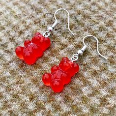 A pair of super cute Red Gummy Bear earrings.  The bears are made from resin so they are hard and long lasting.  They are very realistic so keep out of reach of children! Silver alloy hooks complete these lovey pieces. Fun Red Resin Earrings, Fun Style Red Resin Earrings, Fun Red Resin Jewelry, Red Resin Novelty Earrings, Red Resin Novelty Jewelry, Novelty Red Resin Jewelry, Handmade Red Plastic Earrings, Red Plastic Earrings For Gift, Red Novelty Plastic Jewelry