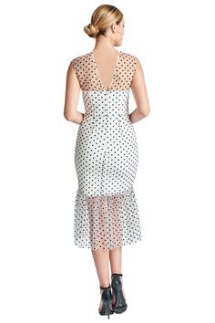 Model wearing white mesh with black polka dots sleeveless midi dress with sheer ruffle hem and round neckline. Fitted Swiss Dot Knee-length Dresses, Fitted Knee-length Dresses With Swiss Dot, Fitted Knee-length Swiss Dot Dresses, Fitted Polka Dot Midi Dress With Swiss Dot Details, Swiss Dot Midi Party Dress, Polka Dot Swiss Dot Midi Dress, Fitted Swiss Dot Midi Dress, Chic Fitted Swiss Dot Midi Dress, Elegant Sleeveless Mesh Midi Dress