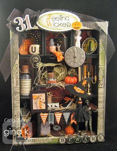 an altered photograph of halloween items in a shadow box with the words 31 below it