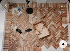 an overhead view of a brick floor with various items on the floor and around it