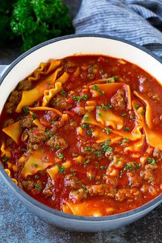 a pot filled with pasta and meat sauce