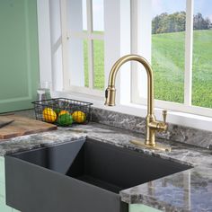 a kitchen sink sitting under a window next to a cutting board