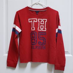 Tommy Hilfiger Boys' Xl Long Sleeve Red White Blue T Shirt Stripe On Arms 60% Cotton, 40% Polyester Excellent Condition New Without Tags Sporty Red Tops For College, Red Sporty Tops For College, Red Collegiate Cotton Top, Collegiate Long Sleeve Red T-shirt, Red Collegiate Long Sleeve T-shirt, Tommy Hilfiger Cotton College Tops, Casual Tommy Hilfiger Tops For College, Tommy Hilfiger Casual Tops For College, Red Long Sleeve Collegiate T-shirt