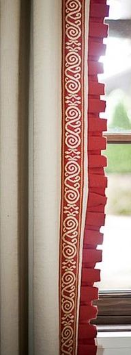 a window with red and white curtains next to a window sill in front of a window