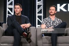 two men sitting on couches in front of a screen with the words kick written on it