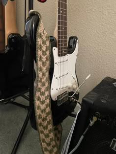 an electric guitar is sitting next to other guitars