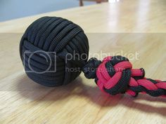 a black and pink tug rope on top of a wooden table