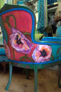 a painted chair sitting on top of a hard wood floor