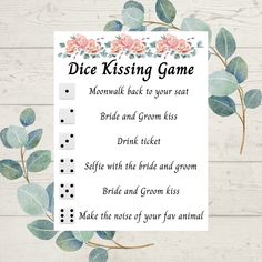 a sign that says dice kissing game with flowers and leaves around it on a white wooden background