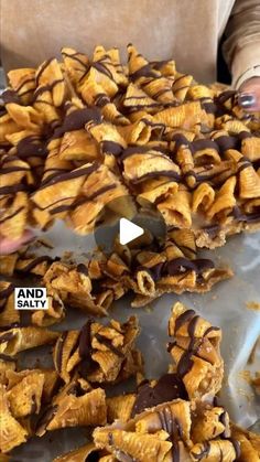 some kind of food that is on top of a table and someone holding it in their hand