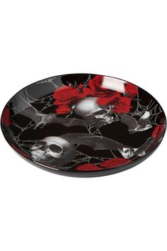 a black and white plate with red flowers on it