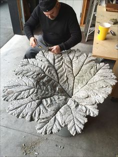 a man is working on a sculpture in the process of making it look like leaves