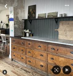 an old wooden dresser with numbers on the top and bottom, sitting in a room