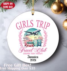 a round ornament with the words girls trip and luggage on it next to christmas ornaments