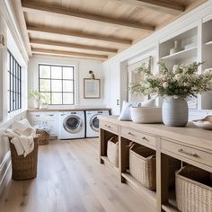 a washer and dryer in a room with wood floors, white walls and ceiling