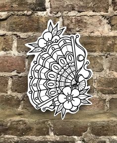 a sticker on the side of a brick wall with an image of a flower