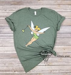 a green shirt with a tinkerbell on it