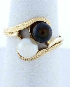 Ladies 14k Yellow Gold (not plated or filled) Black & White Imitation Pearl Ring! June Birthstone Weight: 2.5 grams Width: 12mm (.47") Stone Type: 5mm Round White Imitation Pearl 5mm Round Black Imitation Pearl Hallmarked: 14k Size: 4 3/4 (resize is available) FREE gift box 100% Satisfaction Retail: $439.00 091611.28695 Luxury Handmade Yellow Gold Pearl Ring, Textured Ring, June Birthstone, Pretty Rings, June Birth Stone, Pearl Ring, Classic Elegance, Free Gift, Free Gifts