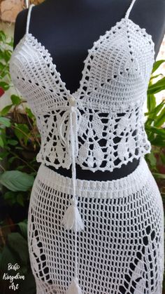 a white crochet dress on a mannequin