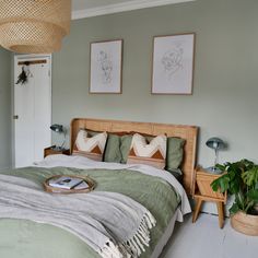 a bed room with a neatly made bed and two pictures on the wall above it