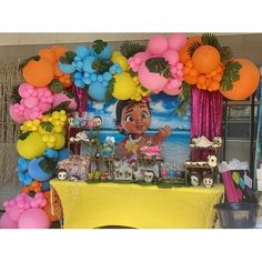 the table is decorated with balloons and decorations