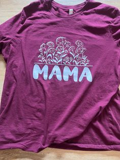 A perfect gift to a Mama or to spoil yourself if your a Mama. Can change color of shirt or design. Casual Shirt With Custom Print For Mother's Day, Pink Floral Print Top For Mother's Day, Pink Floral Print Tops For Mother's Day, Pink Shirt With Custom Print For Mother's Day, Spring Gift Shirt With Relaxed Fit, Mother's Day Floral Cotton Top, Mother's Day Floral Print Cotton Shirt, Graphic Tee Tops For Spring, Casual Floral Print Top For Mother's Day