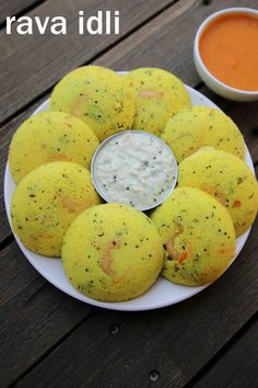 some food is on a white plate with dipping sauce